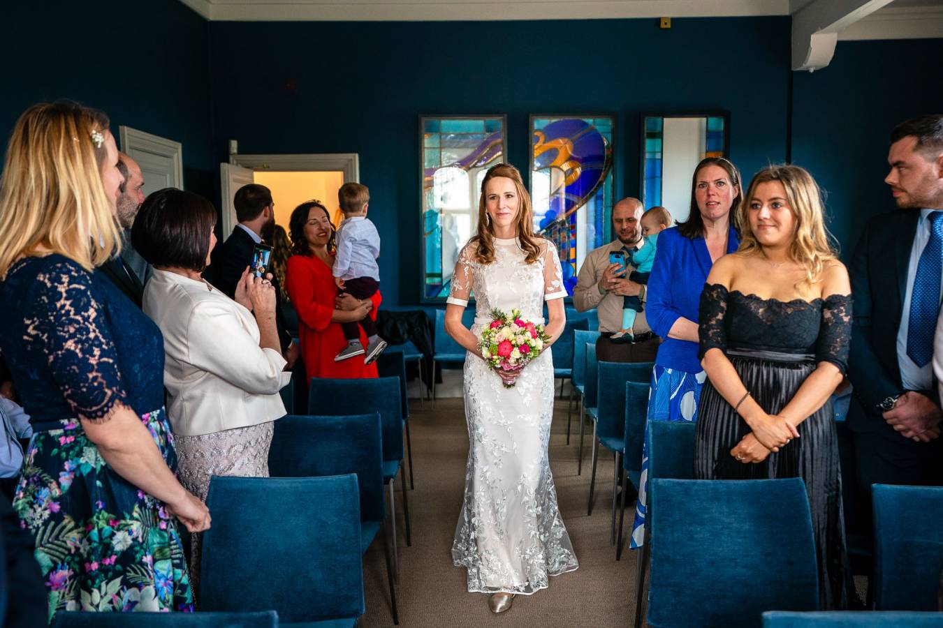 The Castle Room at Winchester Registry Office. Bride walking down the aisle on her own