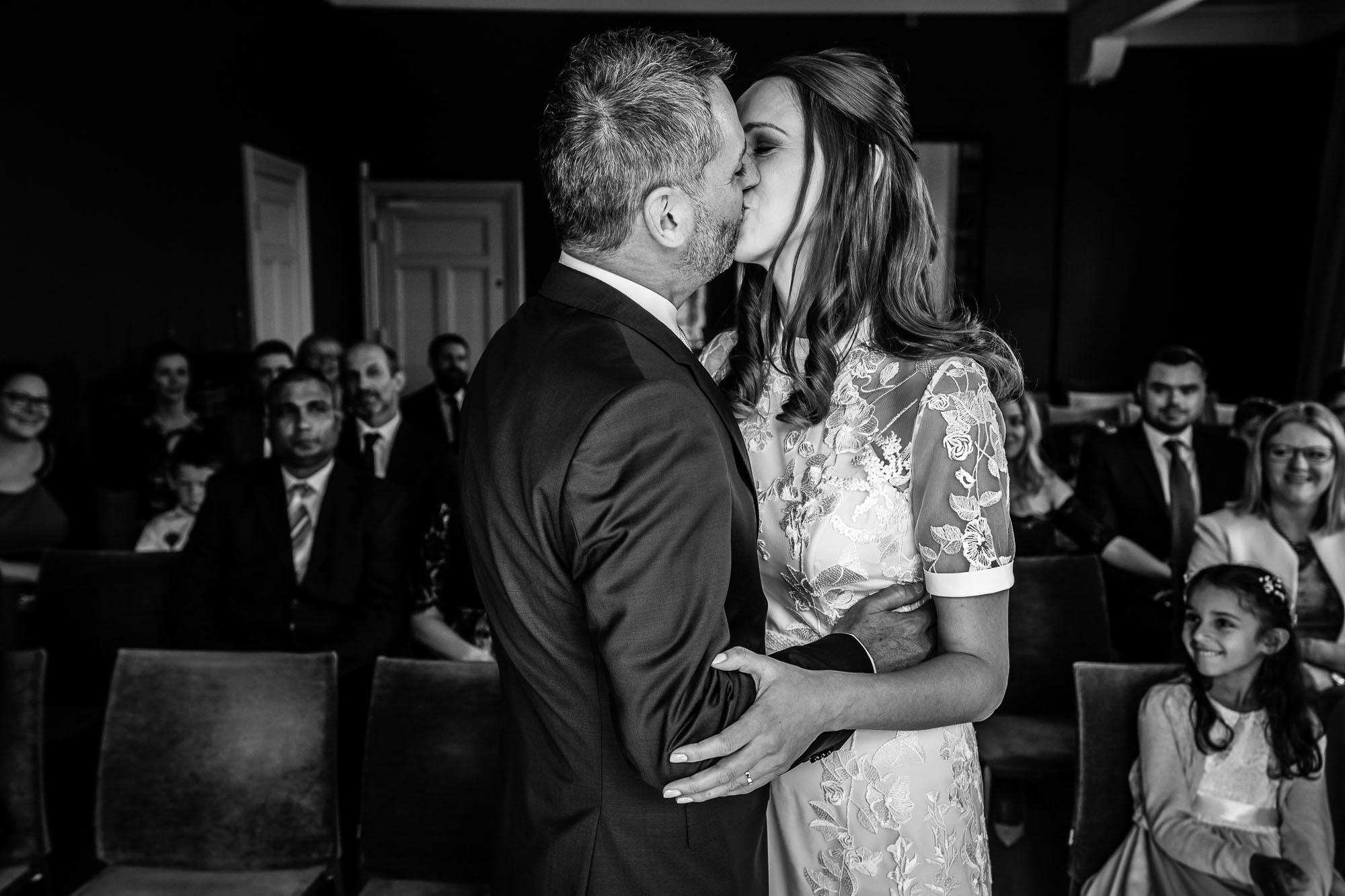 BW photo, first kiss in the Castle Room at Winchester Registry Office