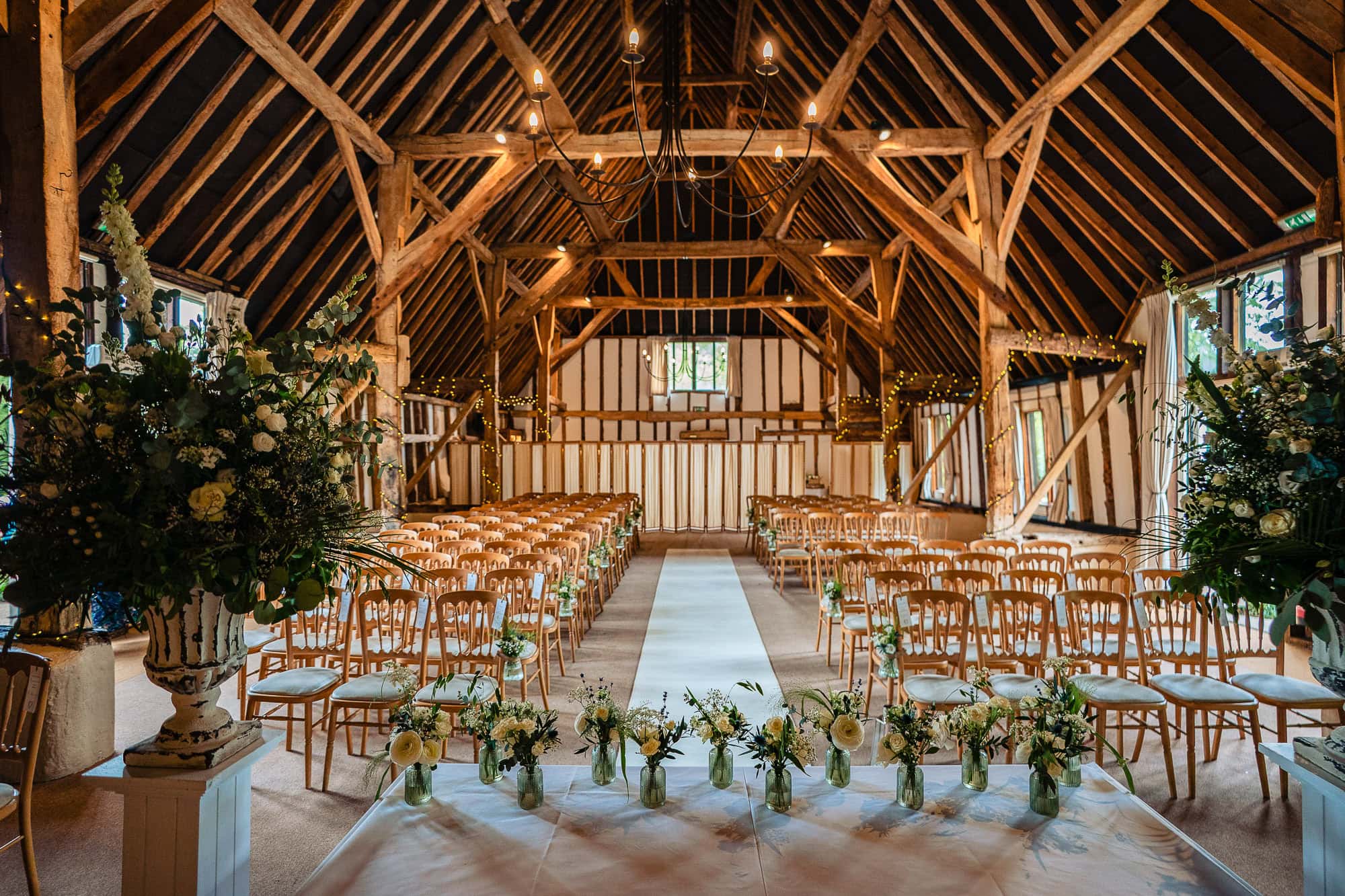 Clock Barn Wedding. The main barn set up for a wedding with white flowers.