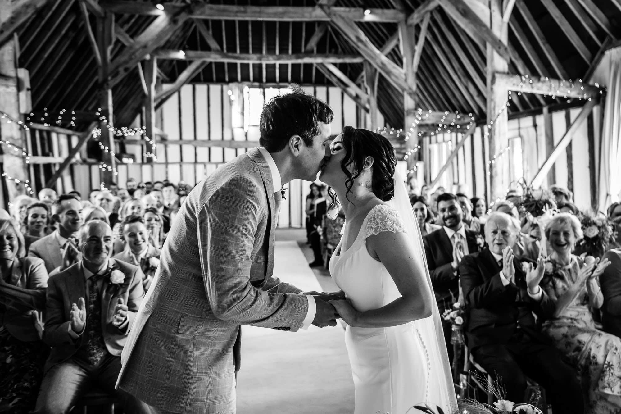 Wedding First Kiss, Clock Barn wedding photography by Tansley Photography - B&W photo